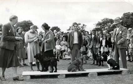The dog show at Pickering's first carnival in 1949. In the centre is Bernard Collier with his dog; on his right is Sally Honess and her dog.