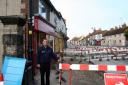 Dave Avison amid the road works in Norton where the pavement in Commercial Street is being dug up .