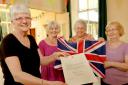 Sheila Harrison, Mary Gray, Margaret Sellers and Josie Thrower with their letter from Buckingham Palace