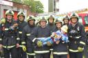 Jamie Inglis gets a helping hand from the team of firefighters of Red Watch at Gipton Fire Station