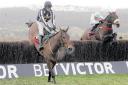 Cape Tribulation, far right, ridden by Denis O’Regan, gains ground and eventually beats Imperial Commander, left, to win the Argento Chase at Cheltenham