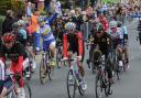 Sir Bradley Wiggins, centre, rides inside the peloton as it made its way along Westgate