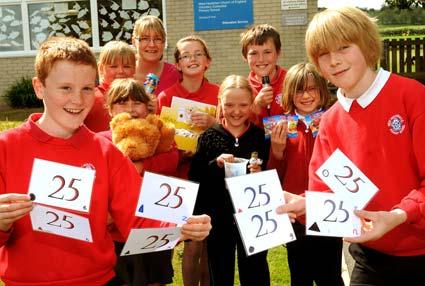  West Heslerton Primary School pupils and, back, headteacher Rachel Wells who held a 25 Day event to support St Catherine’s Hospital 25th anniversary.
