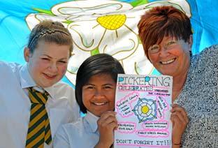 Verity Allen and Luket Hongsa from Pickering’s Lady Lumley’s School show one of their Yorkshire Day poster designs to Coun  Natalie Warriner of Pickering community events 
group.
