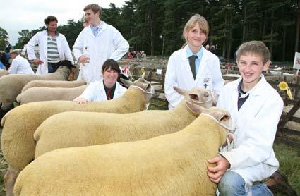 George Bulmer,with his sister Maisie,and Tina Dougherty whose Sharolais sheep from the shamrock Flock at Kirbymisperton, won the group of three interbreed section at Malton Show. 
