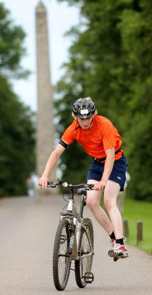Competitor Edward Cooke dismounts his bike at speed during the Castle Howard Triathlon.