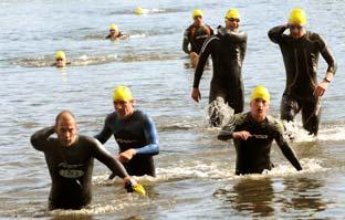 Swimmers emerge from the lake during the Castle Howard Triathlon.