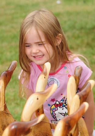 Isabella Ineson inspects some wooden geese. 