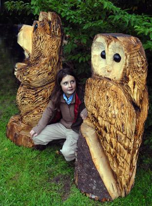 a young visitor with some of the animal sculptures at the Wild About Wood event at Castle Howard.