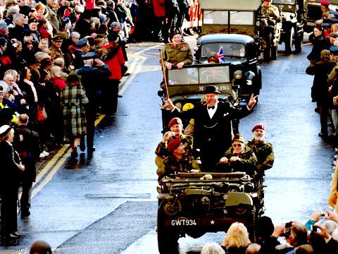 Winston Churchill takes the plaudits of the crowd as his military parade goes through the streets of Pickering