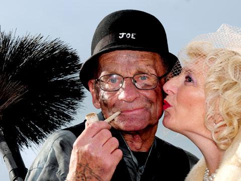 Chimney sweep Dinky Trevor Palmer gets a lucky kiss from Wendy Cross