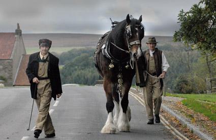 David Hesketh of Burythorpe, and Penny Johnson of Yearsley, with Prince, a working shire horse, at Goathland. 