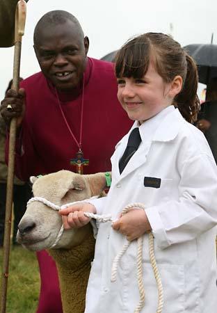 The Archbishop of York Jon Sentamu meets six year old Molly Dougherty of Kirbymisperton with her Charolais sheep at Malton Show