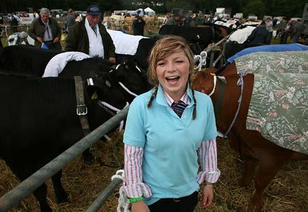 Hannah Donaldson of Hazel House Farm, Huby, stands in front of her family's cows wrapped up in curtains to protect them against the rain 