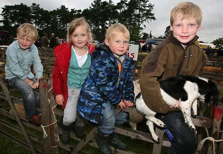 Harry and Alfie Barker with their puppy Brownbull, with Lottie and Henry Vickery in between them at the Malton Show where they showed their Fat Lambs