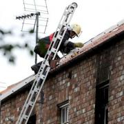 A fireman on the roof of the wrecked flat