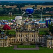 Hot air balloons above Castle Howard. Today's planned mass balloon launch has been delayed until 7pm because of rain