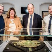 Phil Crabtree, Chairman of Malton Museum, Paula Ware, from MAP Archaeological Practice, Kevin Hollinrake MP and Scott Waters, Managing Director for Persimmon Yorkshire with the shield which was displayed at the museum earlier this year.