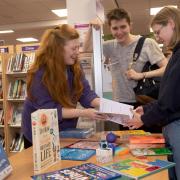 Outreach librarian Claire Thompson, left, shares North Yorkshire Libraries' free Self-Care Toolkit with interested teenagers.