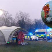 The 'alien spacecraft' under its forensics tent at Lord Deramore's Primary. Inset: forensics scientists in hazmat suits take a closer look at the 'UFO'