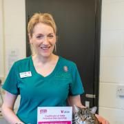 Minster Vets veterinary nurse Jane Owen with Florence the cat and the ISFM certificate.