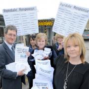 Campaigners Dr Mike Lynch, left, and Coun Lindsay Burr with hospital staff and some of the petitions asking for a rethink on the Malton Hospital’s Minor Injuries Unit