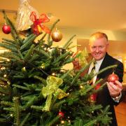 Paul O’Hanlon, general manager of the Black Swan, in Helmsley, with one of the decorated trees which feature at the festival at All Saints Church