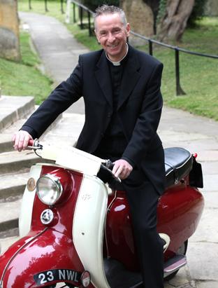 Father Antony Pritchett the vicar of St Peters and St Pauls in Pickering on a 1960's scooter, part of an exhibition in the church to mark 60 years of the Queen's reign. 