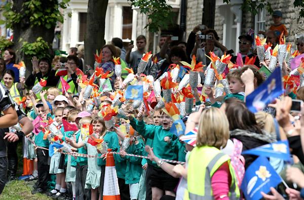 Local schoolchidren wave their homemade Olympic Torches as they support the Torch Relay in Pickering 
