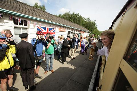  Kelly Williams holds the Olympic Flame out of the window of the steam locomotive The Green Knight as it passes through Crosmont station 