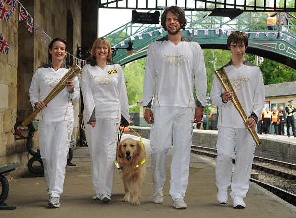 Pickering's Olympic torch carriers. Pictured from the left are Vanessa Buckle, Alison Bates with guide dog Jake, Olympic rower Tom Ramsley, and Max Strachen.