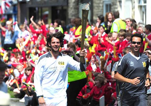 Tom Ransley carries the Olympic Torch in Pickering 