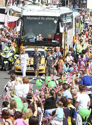 Crowds cheer on the Olympic torch in Northallerton