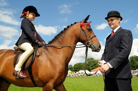 Barkway Grenadier, champion in the Lead Rein Pony class, with Harriet Weir, aged 7, and owner Robert Flintoft
