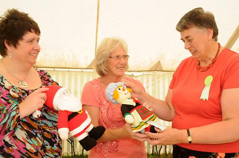 Judge Glenys Rowe, right, with assistants Karen Hartass, left, and Christine Anderson, centre, looking at entries in the knitted toy class