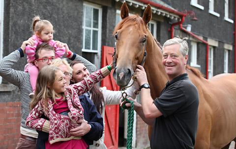 Graham Gray, Travelling Head Lad at John Quinn's stables introduces New Planet to a family at Malton Stables Open Day. 