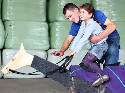 A youngster has a go on the Equiciser at Norton Grange Stables