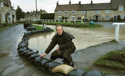 William Worsley keeps an eye on the rising floodwater as sandbags are put in position at Hovingham.
