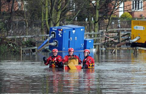 A North Yorkshire Fire and Rescue team work to position a pump into floodwater at Old Malton.
