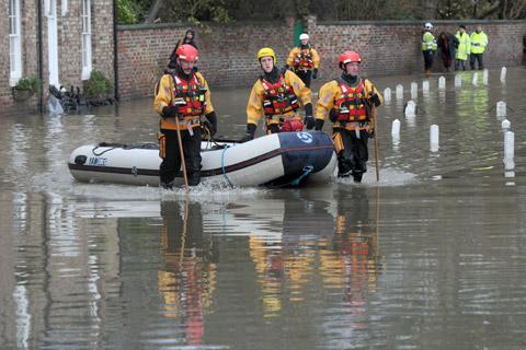 A North Yorkshire Fire and Rescue team with a boat in the floodwater at Old Malton.