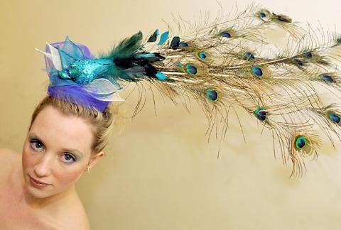 Beth Queen wears an Avant Garde hat made by student Becky Swallow in The Academy annual hair and beauty competition.