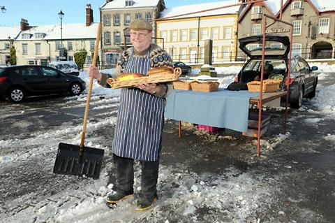Baker Pete Ellison who was the only Malton Market trader to set up stall in the snow.
.