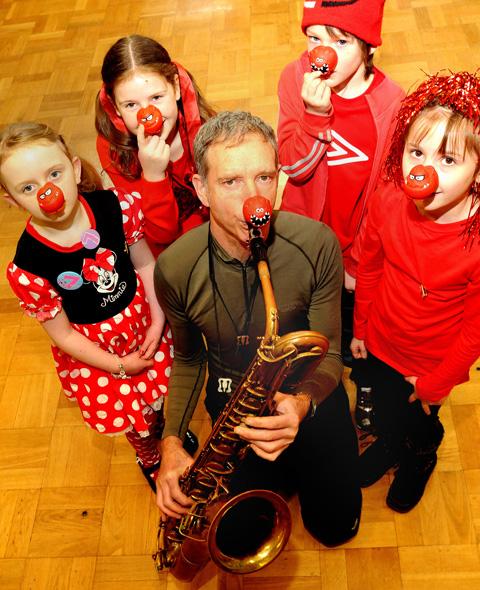 Saxophonist Snake Davis with pupils of Pickering’s St Joseph’s School in fancy dress for Red Nose day