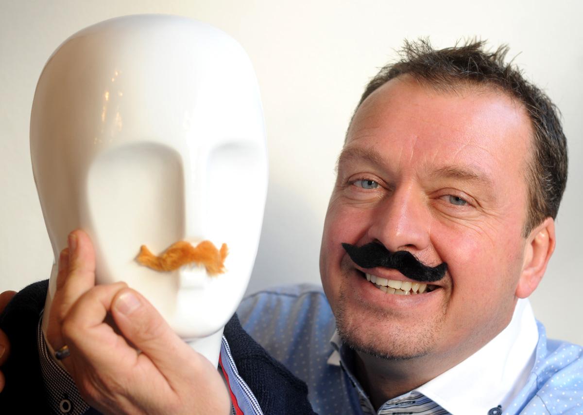  Jeremy Swallow, of Smash Menswear, in Malton, who has organised a competition to     identify famous faces with moustaches for Movember. 