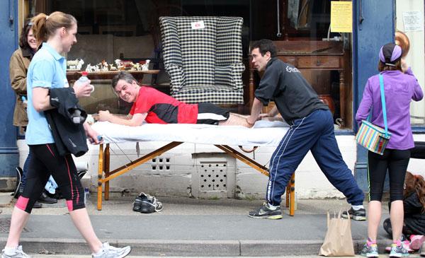 Andy Gamble of Body Basics Fitness Studio in Kirkbymoorside set up tables in the street for the 10k run and gives Gary Barnes of Hareham some physio.