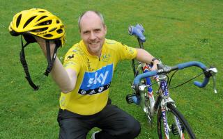 Author Andy Seed holds the cycling helmet worn by last year’s winner of the Tour de France Chris Froome