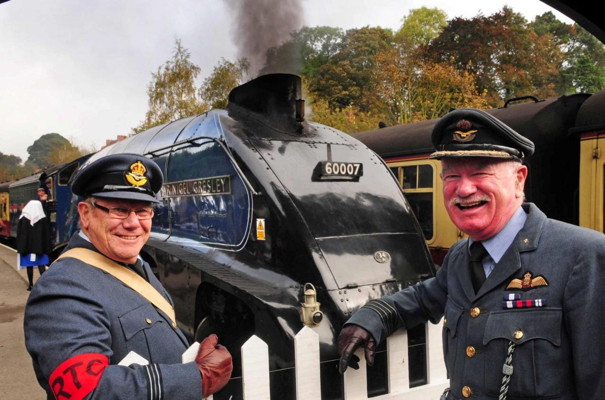 Ron Price and Brian Smith-Lowther cheer the arrival of the Sir Nigel Gresley during the Railway in Wartime event.