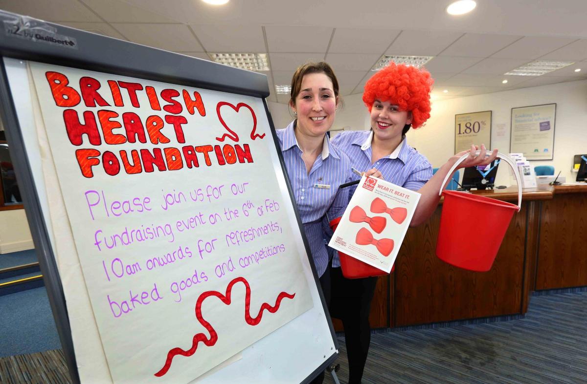 Skipton Building Society customer advisors Sarah Richardson and Gemma Grover prepare for the Wear It Red Day in aid of the British Heart Foundation at their Malton branch on Friday 

Picture: Richard Doughty