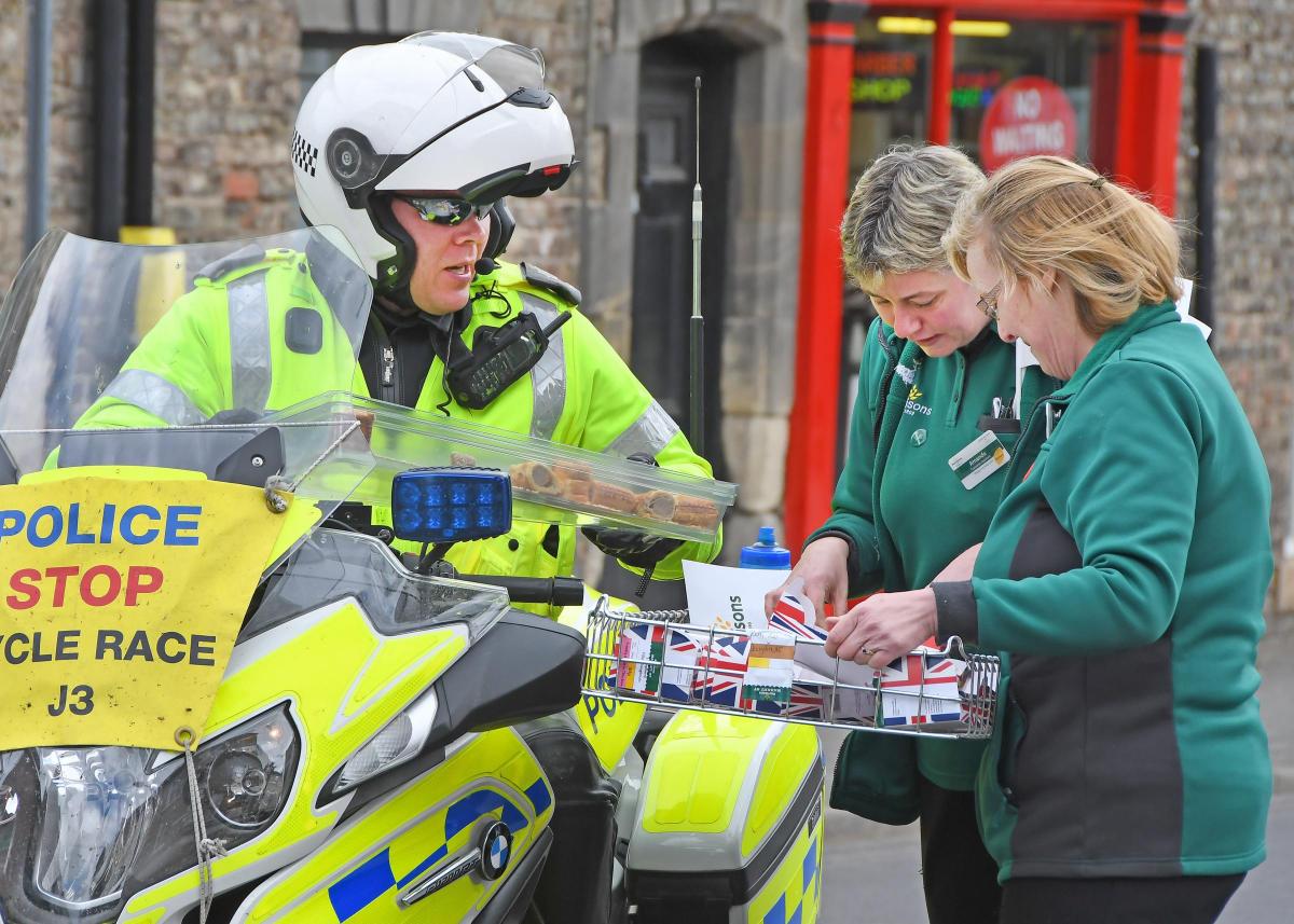 The Tour de Yorkshire in Malton. Pictured a ploice motorcycle rider gets a doughnut from the Morrisons ladies. Picture David Harrison.