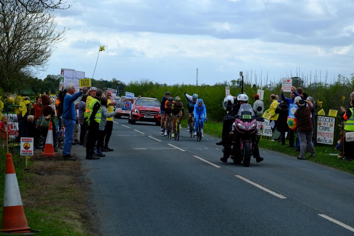 The Stage 1 breakaway riders pass the Kirby Misperton Protection Camp Picture: David Mackie